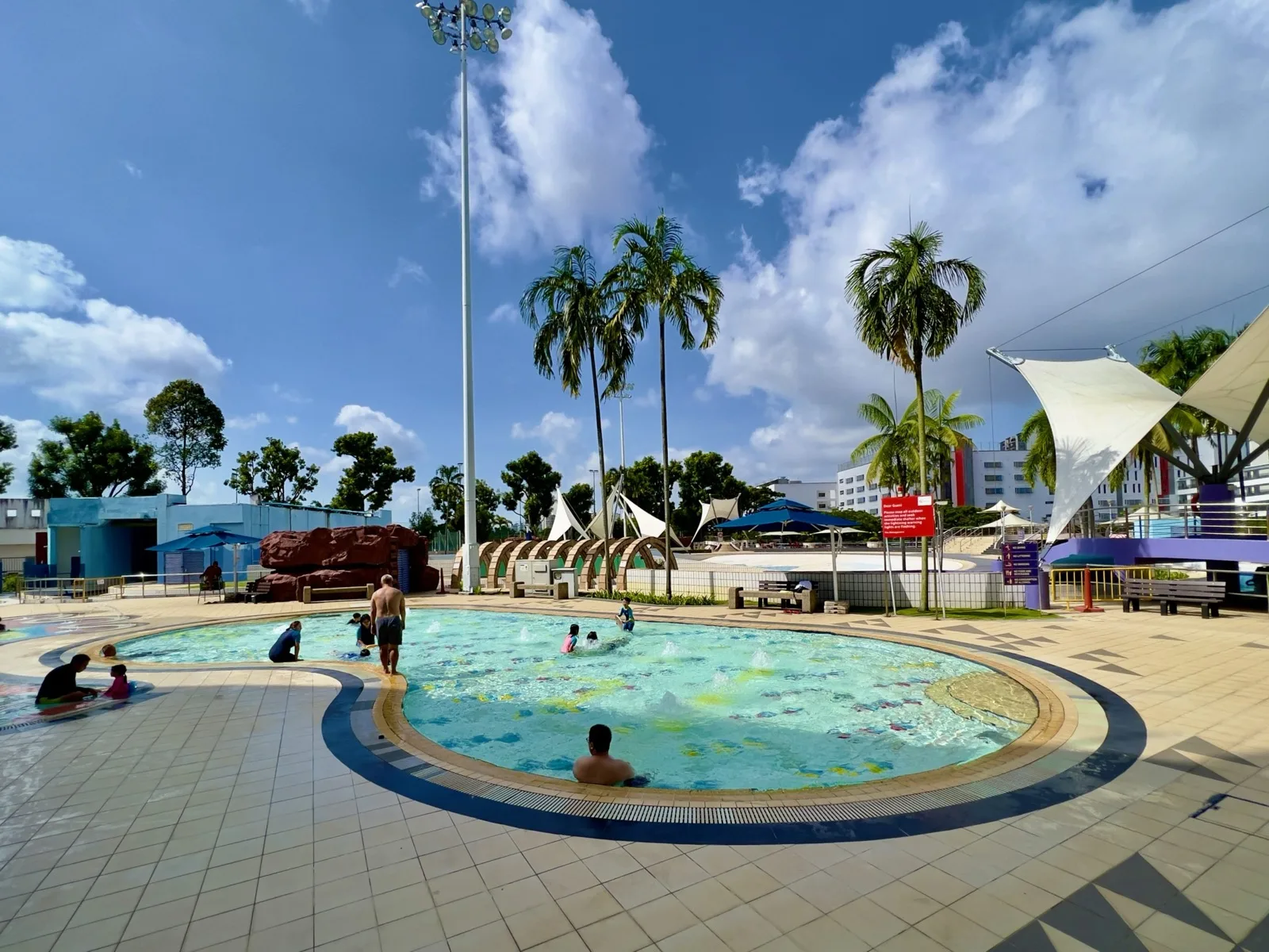 Lazy river winding through the Jurong East Swimming Complex with tropical landscaping